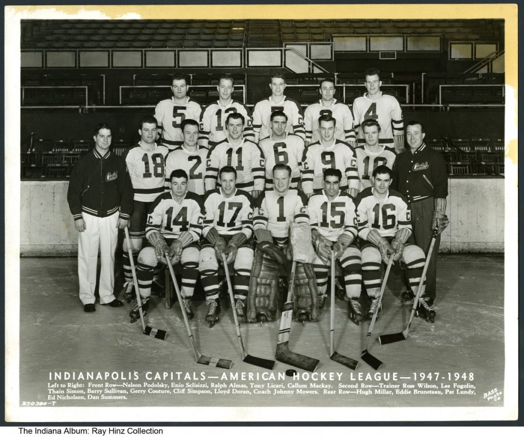 Posed commercial photo of a group of men in hockey uniforms. 