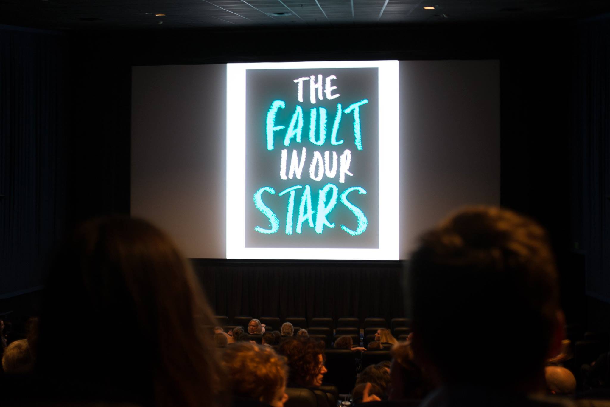 View of the theater screen that show the words "The Fault in our Stars."
