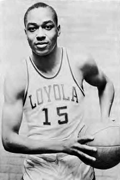 A man poses in his basketball uniform. 