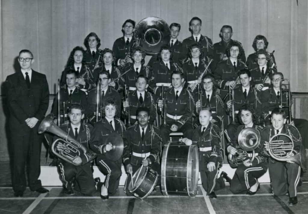 Group photo of students from the Indiana Academy band dressed in their marching uniforms and holding their instruments.