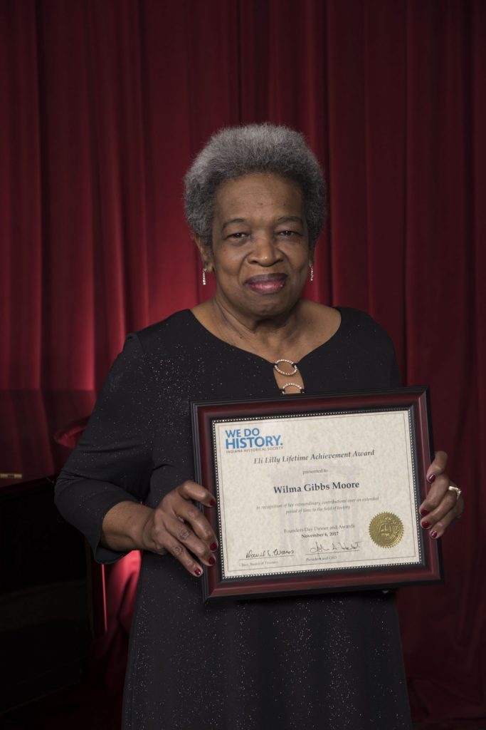 Wilma Gibbs Moore holds her Eli Lilly Lifetime Achievement Award.
