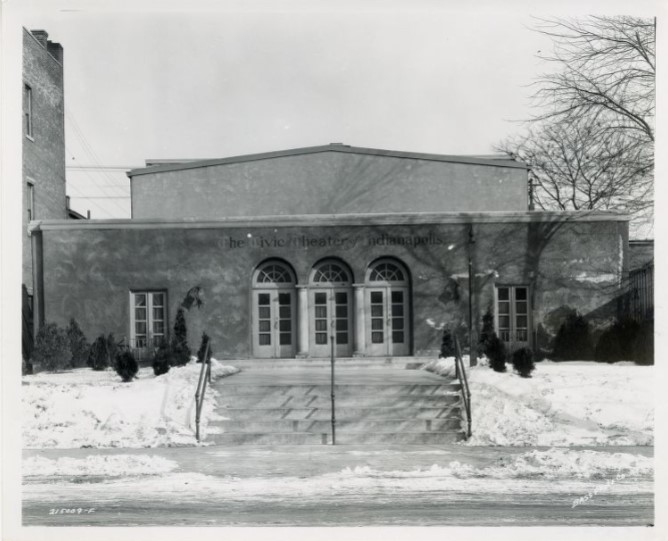 Front entrance of the Civic Theatre building with snow piled up on either side of the steps leading to the entrance.