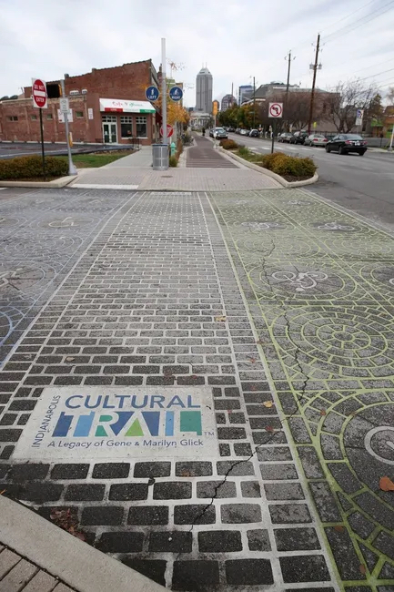 Crosswalk with the pavement decorated with the cultural trail logo.