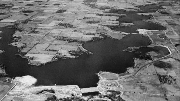 Aerial view of a reservoir surrounded by open grassland.