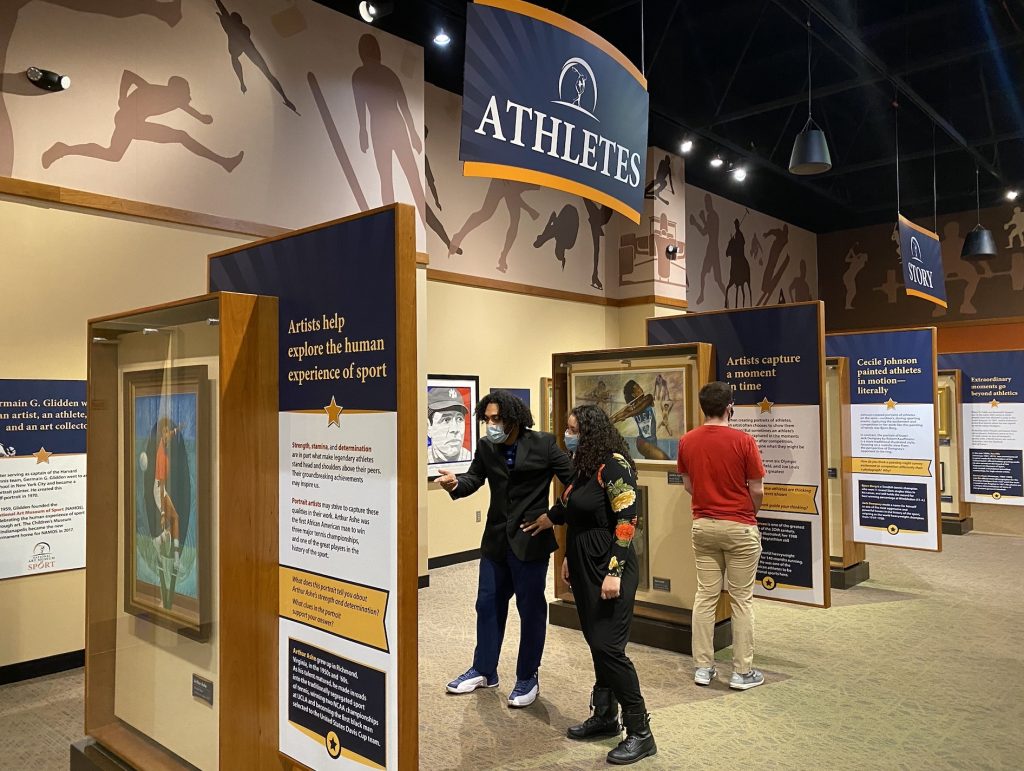 Visitors interact with exhibit labels at the The National Art Museum of Sport.
