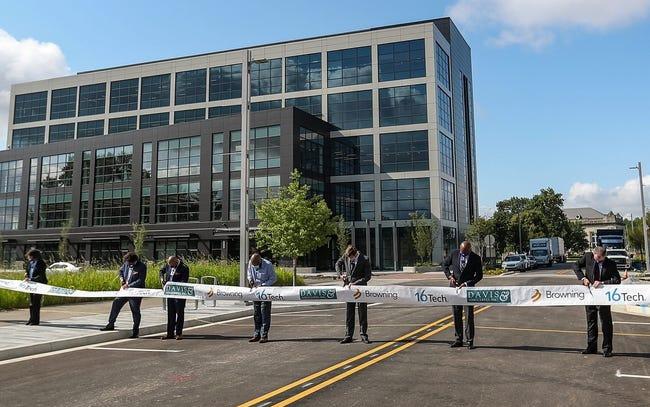 A row of people standing in the parking lot of 16 Tech.