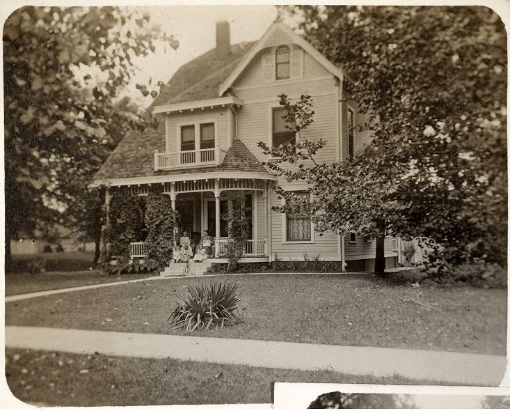 A Dutch Colonial Revival style home with Queen Anne ornamentation.