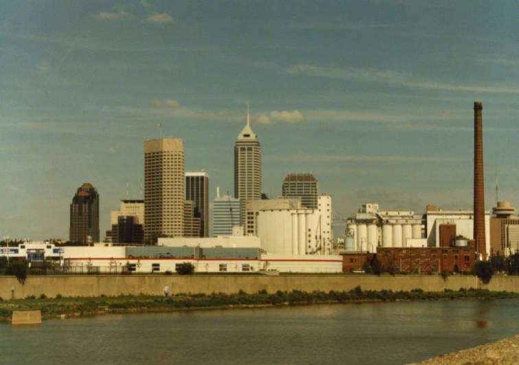 A river is in the foreground. The city skyline is in the background.