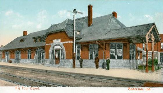 Rendering of a long low building with railroad tracks and three people in front.