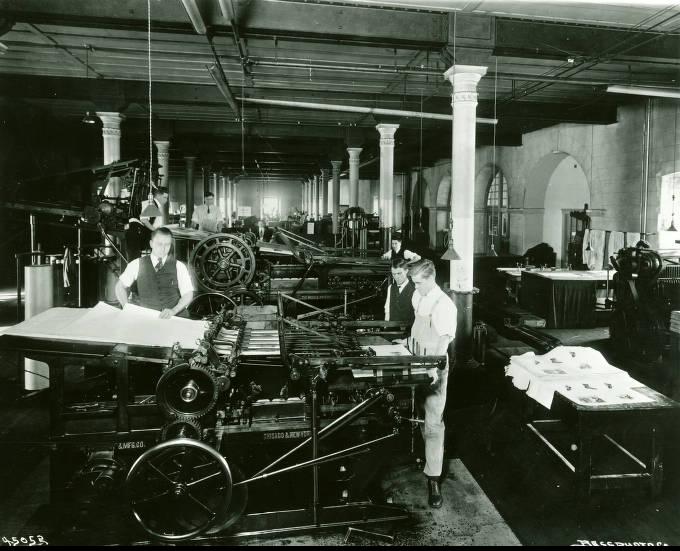 Students operate printing presses.