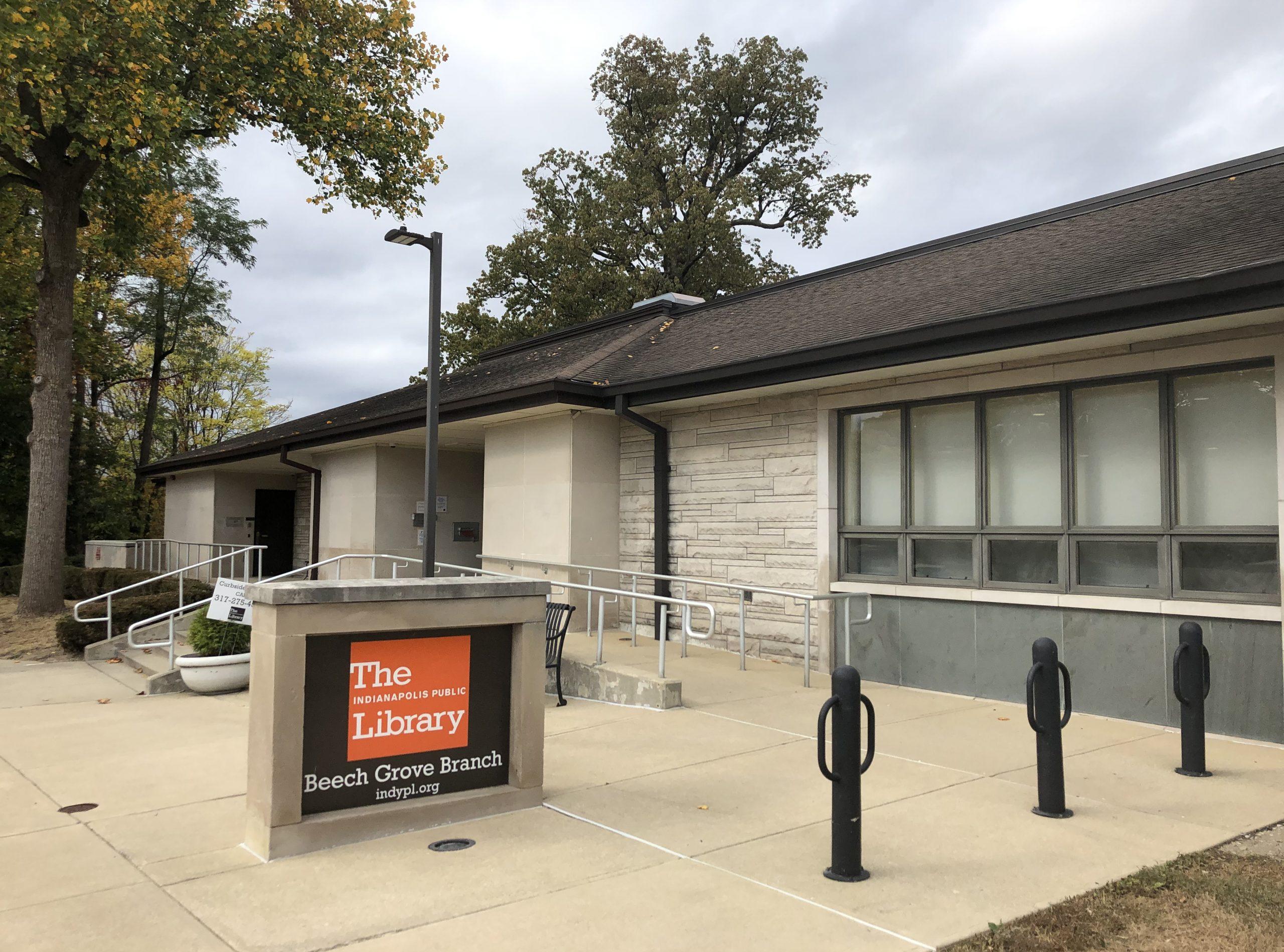 Exterior view of the entrance to a single-story library building. A sign in the front of the building reads "Beech Grove Library."