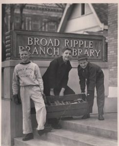 Three boys moving crates of books into the new building of Broad Ripple Branch Library, 1949