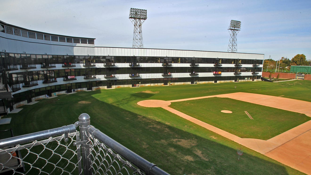 The baseball field is in tact. The encircling stands have been enclosed with windows and lined with black, metal balconies.
