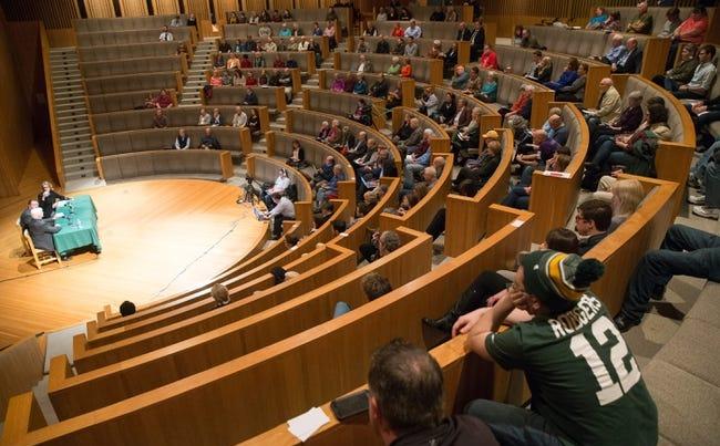 People fill the seats of an auditorium.