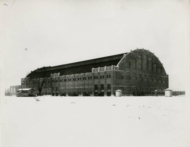 A large building with a rounded roof. There's snow on the ground.