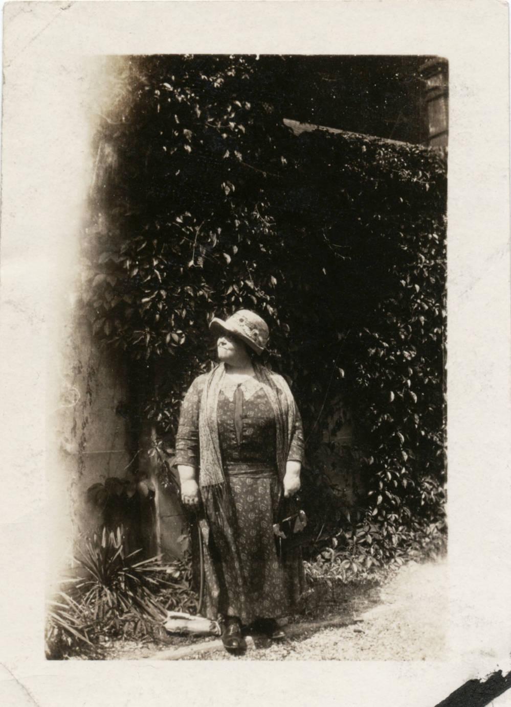 A woman stands outside.