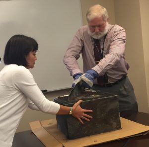 Meaghan Fukunaga and Mike Williams opening the time capsule at Central Library, 2017