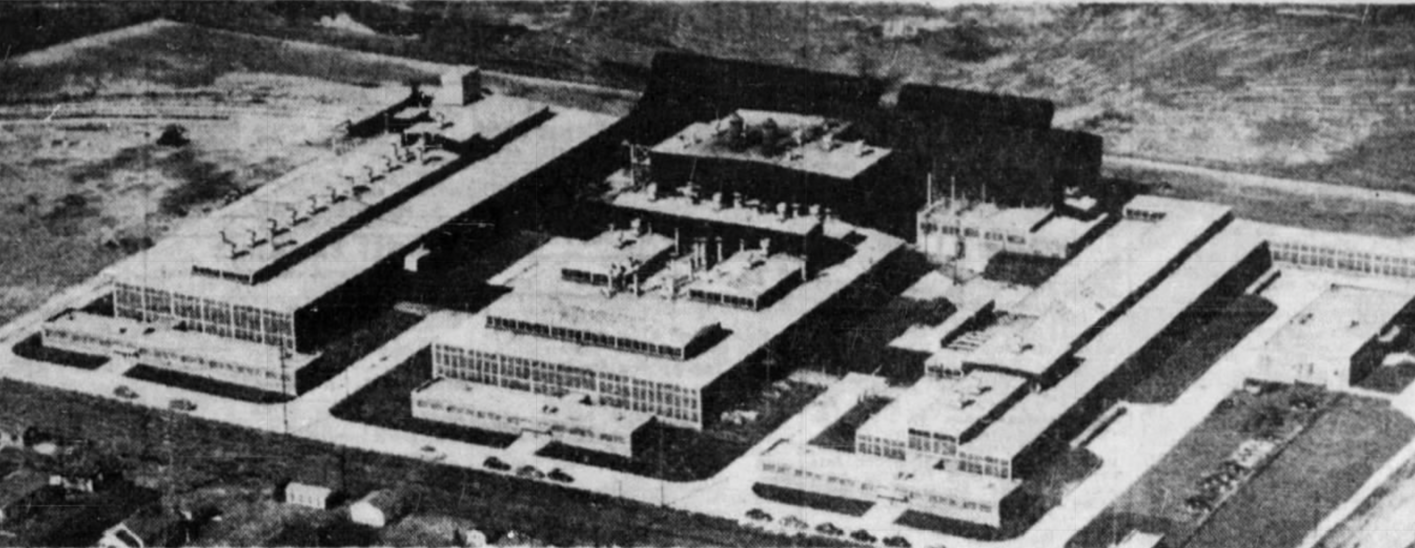 Aerial view showing three connected factory buildings.