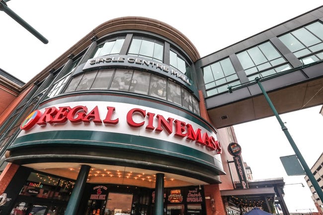A three-story circular tower entrance with "Circle Centre Mall" and Regal Cinemas" signs on it.