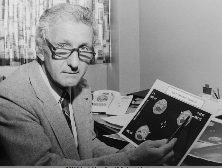 A man holds a scan of a brain.