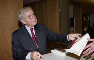 Dan Wakefield signing a copy of Going All the Way, 1997