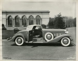 Duesenberg model photographed in front of the Thomas Taggart Memorial at Riverside Park in Indianapolis, n.d.
