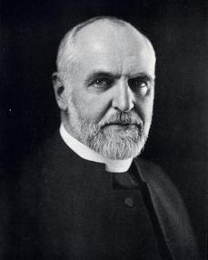 Headshot of a man wearing a clerical collar.