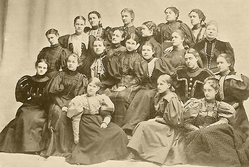 A large group of women pose for a group photo. 