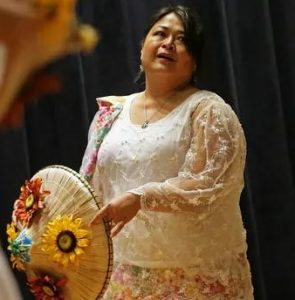 Gigi Thomas, of south side Indianapolis, performs with a conical, an Asian sun hat, during the eighth annual Asian Festival, 2015