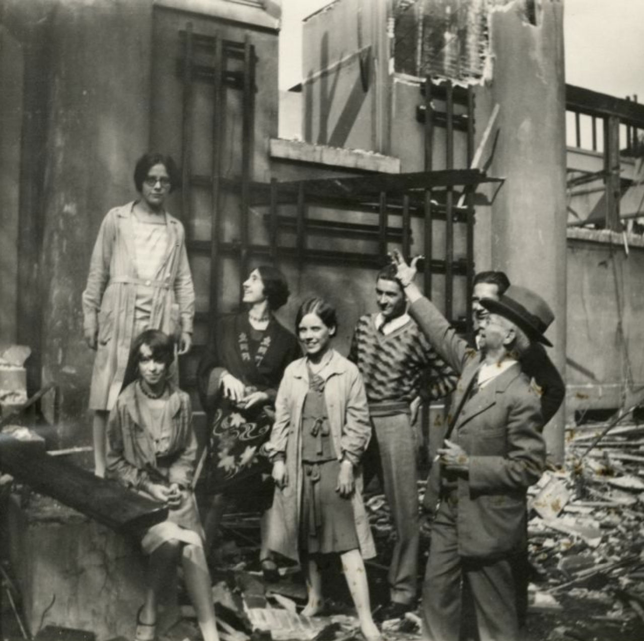 Forsyth and several students stand outside of a partially demolished building. 