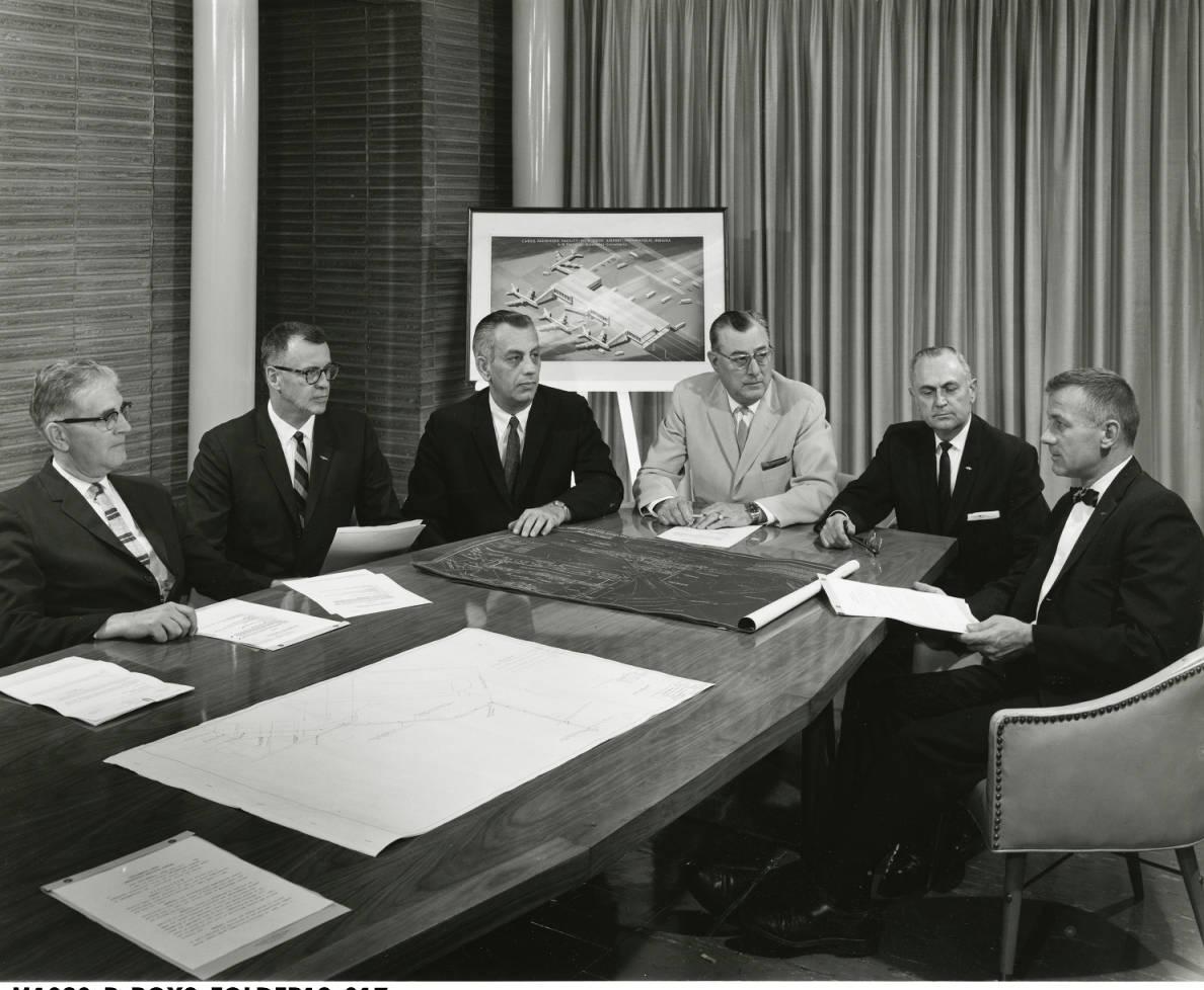 Indianapolis Airport Authority Board Members are seated around a table, discussing plans.