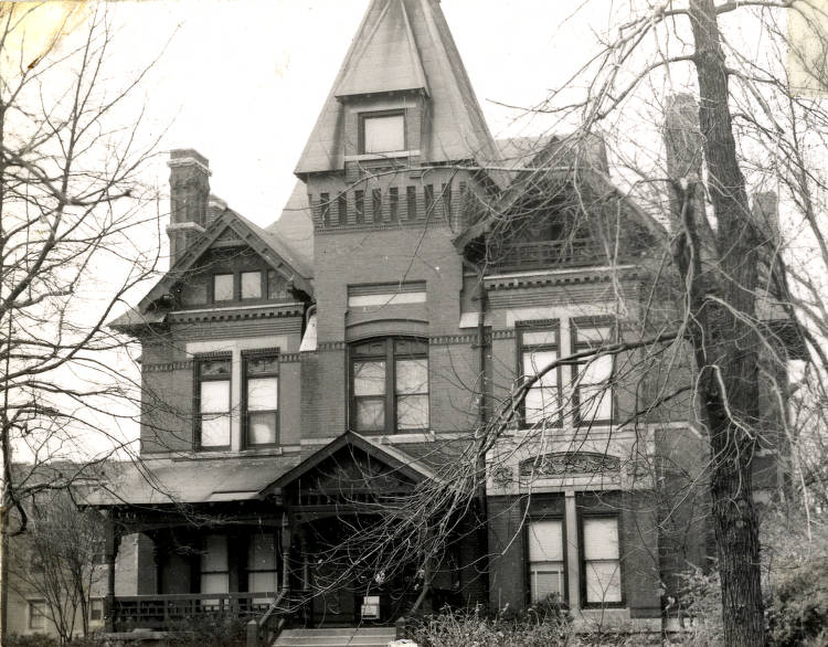 The front of a three-story Gothic Victorian home.