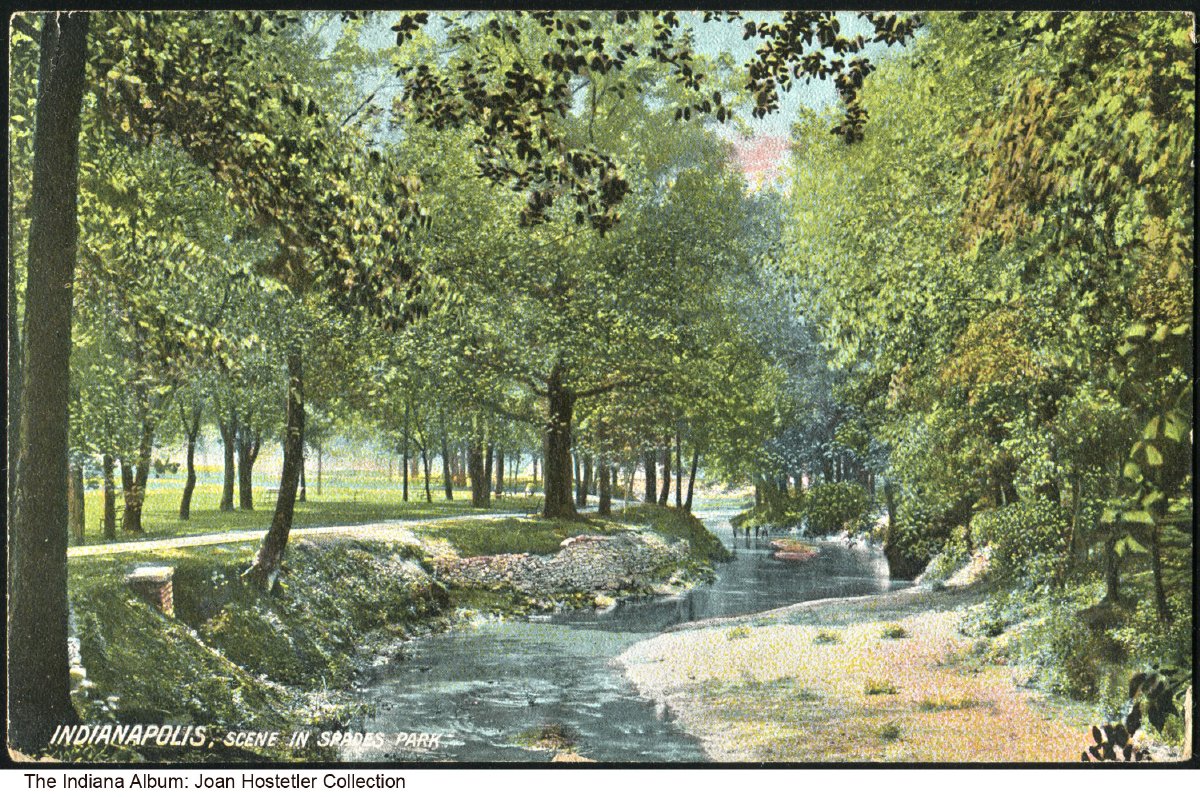 A postcard  showing a creek with trees lining either side. 
