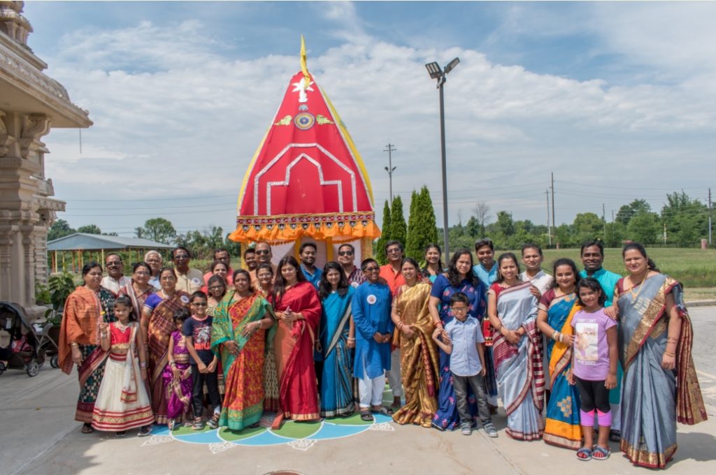 A group of Asian Indian people outside of the Hindu Temple.