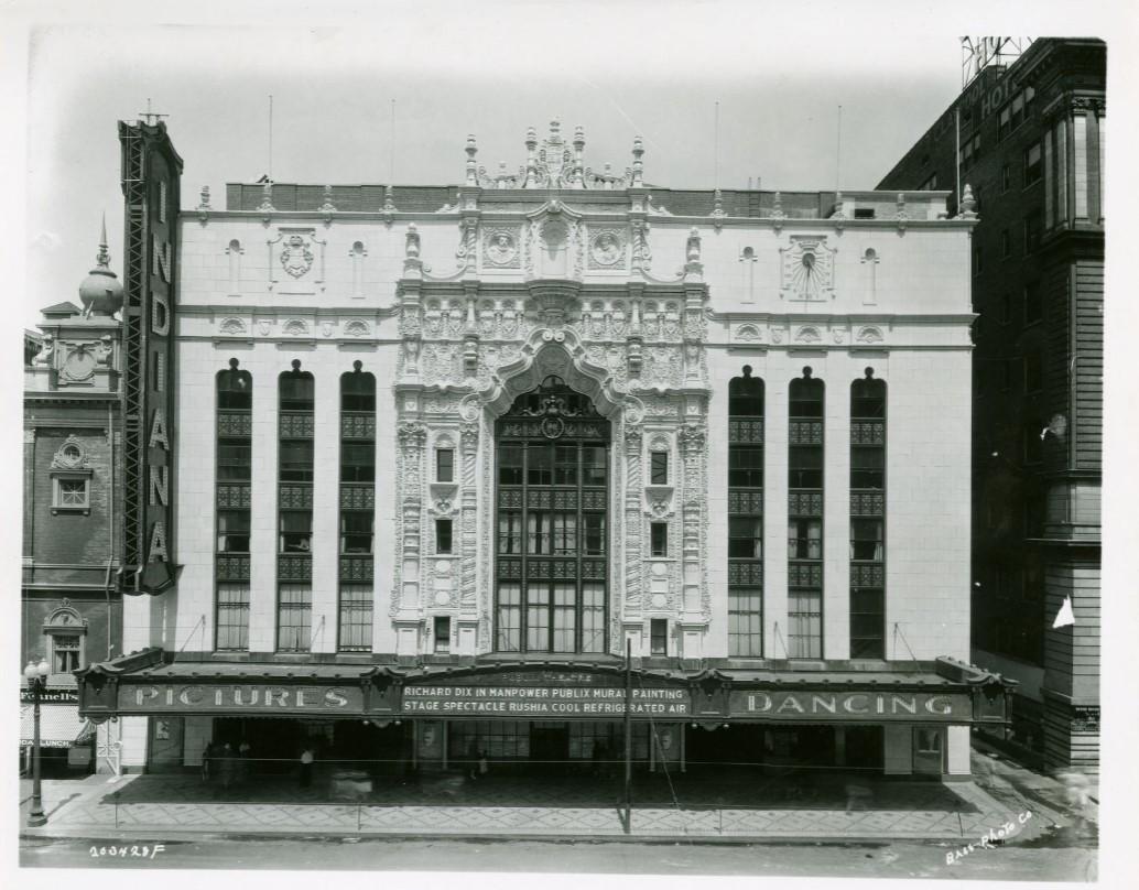 Exterior view of a theater building with ornate façade.
