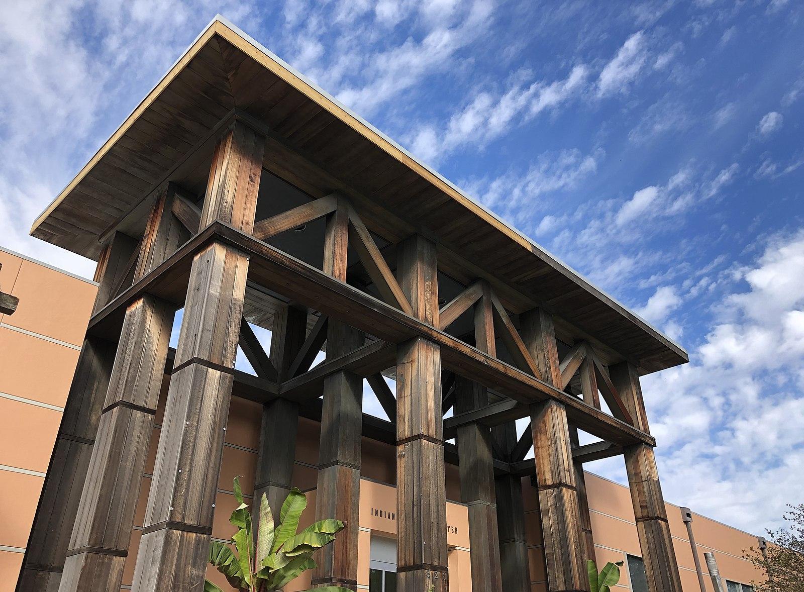 A stucco building entry with large portico columns.