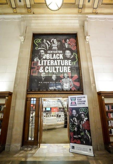 A large banner advertising the Center for Black Literature and Culture is above an open entrance to a large room.