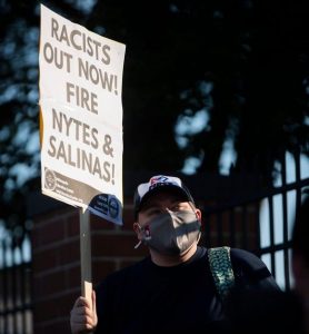 Demonstrator holds a sign during a protest by Indianapolis Public Library employees in Indianapolis, 2021