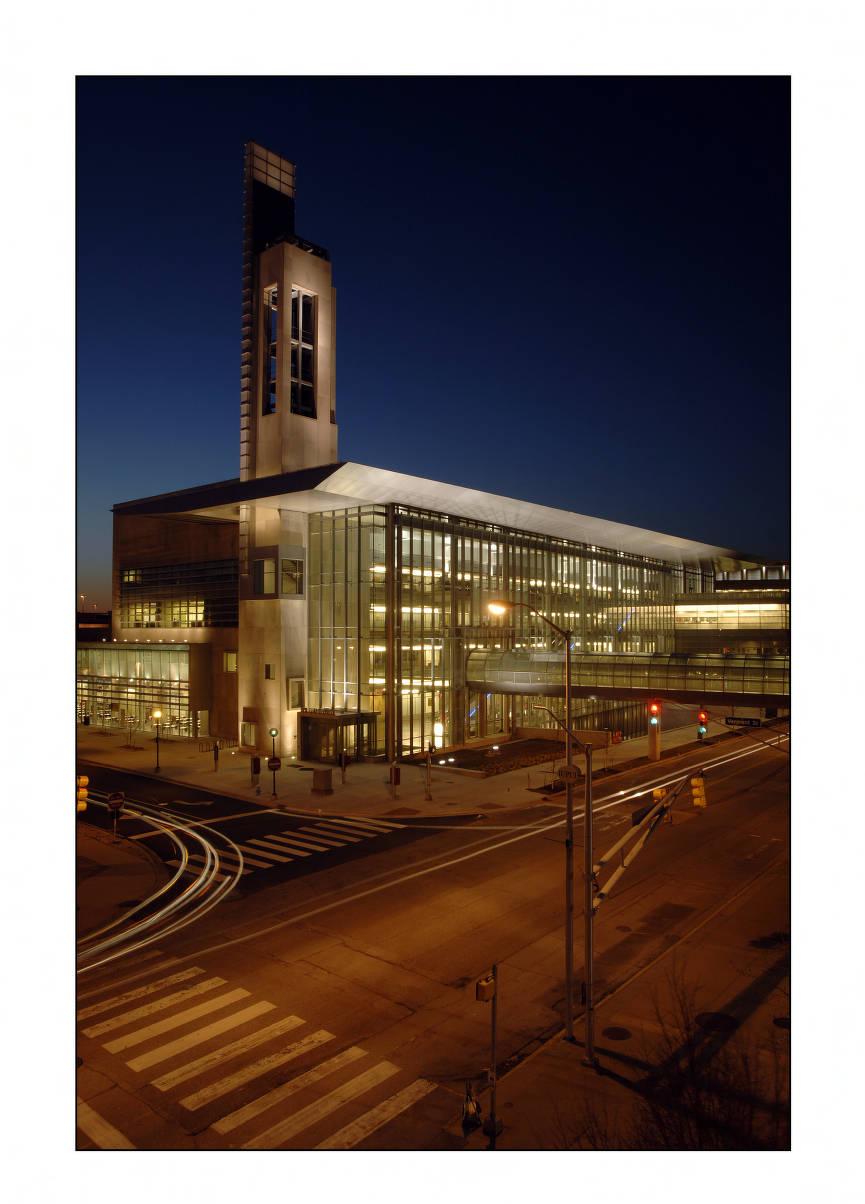 Exterior view of a glass-fronted building at night.