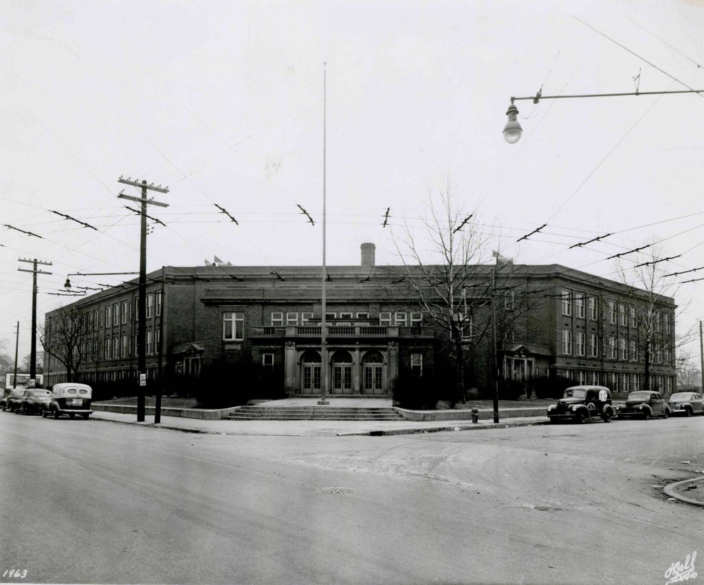 Exterior view of a multistory brick school building.