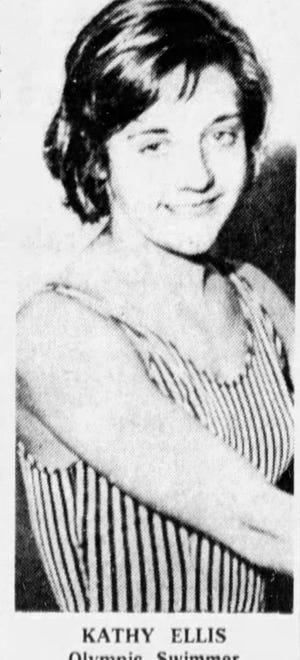 A woman stands in a swimsuit.