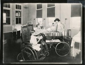 Library hospital service bringing books to patients, ca. 1920s
