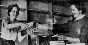 Library staff unbox leftover books from the book fair that were donated to the library by Indianapolis News, 1960