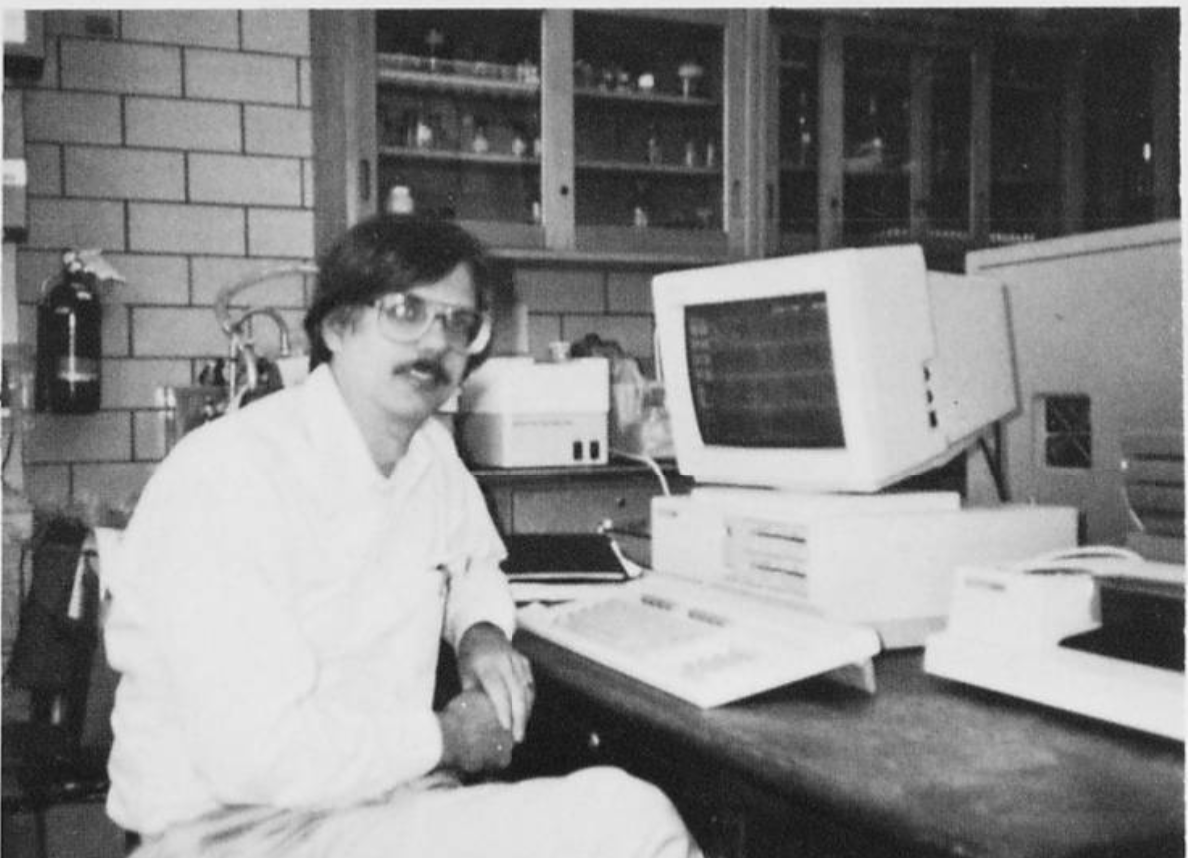 Dr. Howard Edenberg sits in front of a computer in a lab.