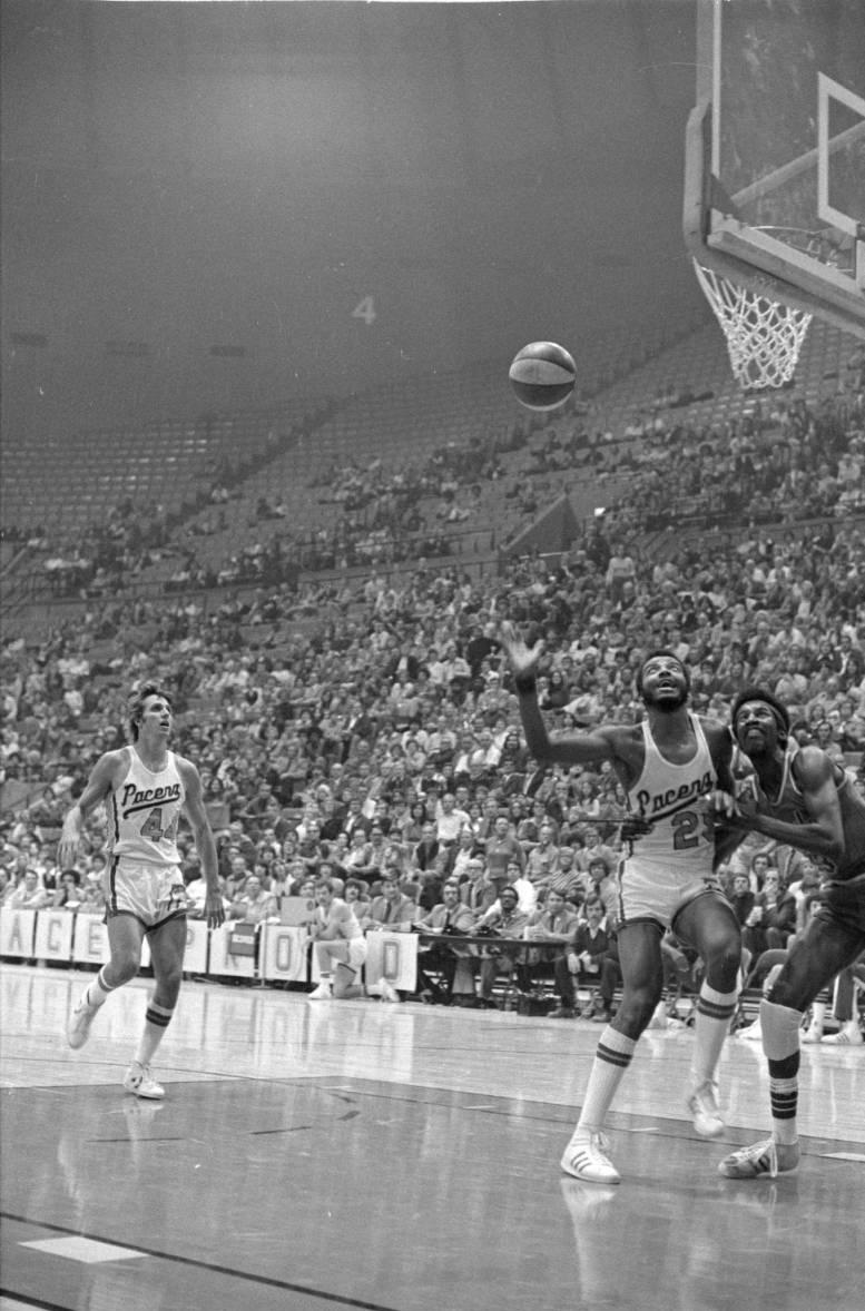 Pacers players Mike Flynn (44) and Billy Knight (25) look to rebound the basketball during a game against the San Diego Sails in the last season of the American Basketball Association (ABA).