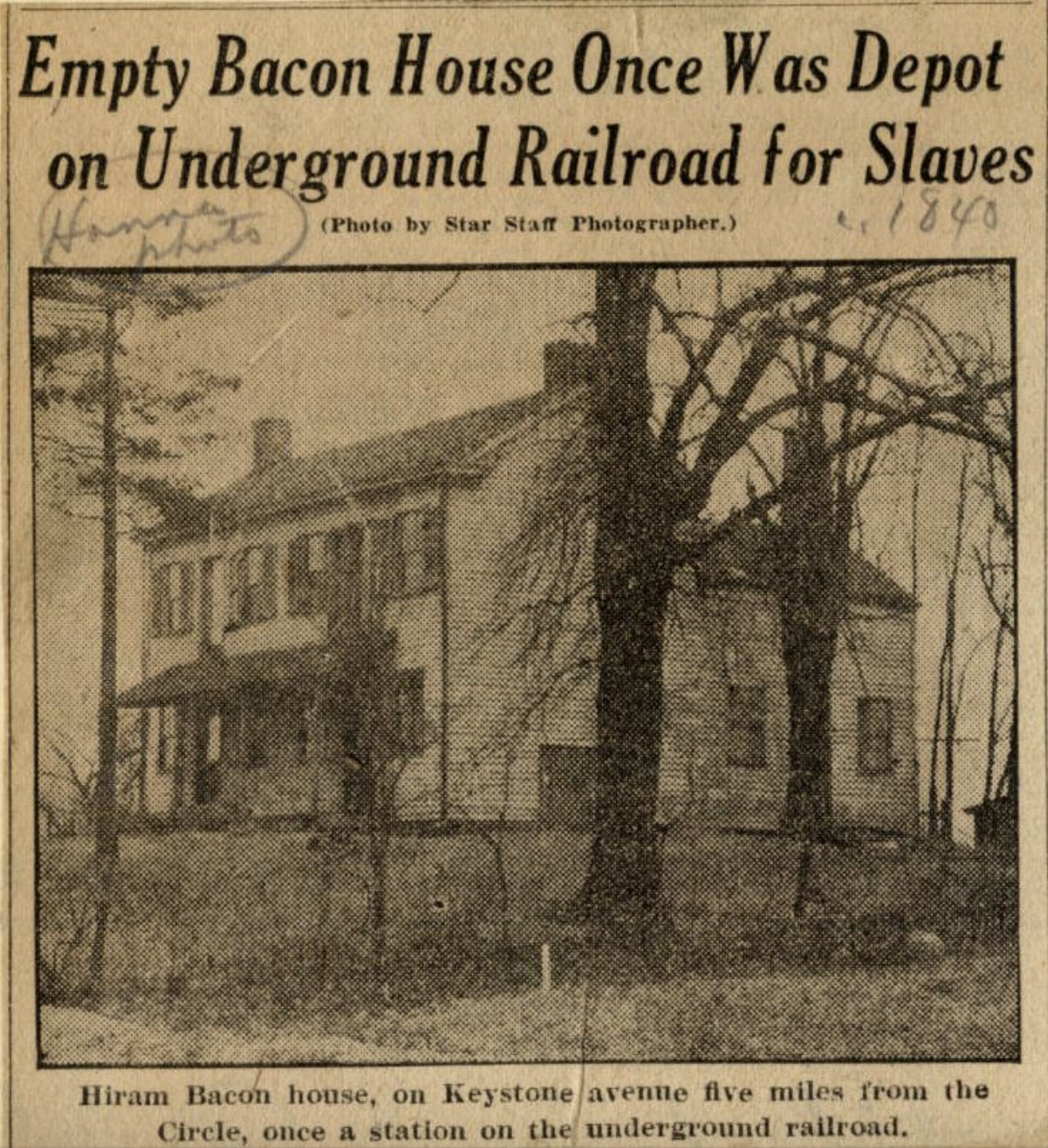 Newspaper clipping shows a photo of a two-story house. The headline above the photo reads "Empty Bacon House Once Was a Depot on Underground Railroad for Slaves". The caption underneath reads "Hiram Bacon house, on Keystone avenue five miles from the Circle, once a station on the underground railroad.