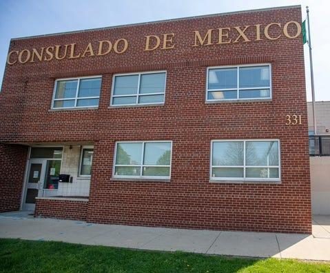 The exterior of the a two-story brick building. Letters affixed to the front read "Consulado de Mexico."