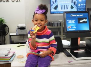 Ka'Zira gets her first library card at Southport Branch, 2021