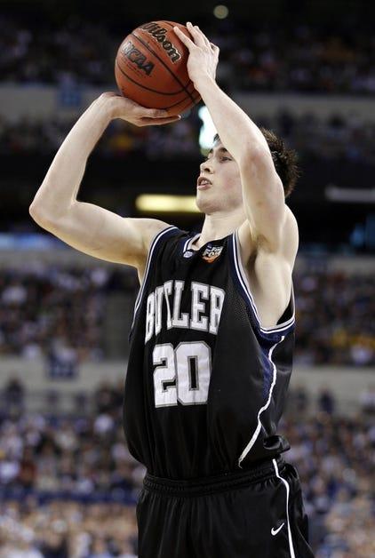 A basketball player is about to throw the basketball.