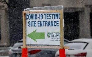 Snow falls on a COVID-19 testing site along east 38th St. in Indianapolis, 2020